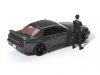 Масштабная модель Nissan GT-R (R32) Nismo с фигуркой Цугио Мацуда 1992 (Nismo Gunmetal) серый ракурс 2