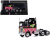 Масштабная модель Kenworth K100 Aerodyne 1976 седельный тягач чёрный с розовым и зеленым 1:64 IXO U64TR006 ракурс 3