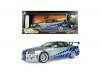 Масштабная модель Nissan Skyline GT-R (BNR34) (1999) Брайана ОКоннера из фильма Двойной форсаж, серебристый с синим 1:18 Solido S1804315A ракурс 11